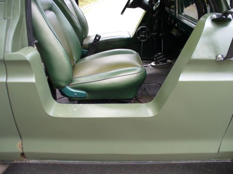 1978 Ford Bronco - The interior of a 1978 Ford Bronco shows green bucket seats and a manual transmission shifter.