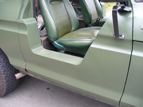1978 Ford Bronco - Interior view of a 1978 Ford Bronco, highlighting its distinctive green two-tone seats and door panel.