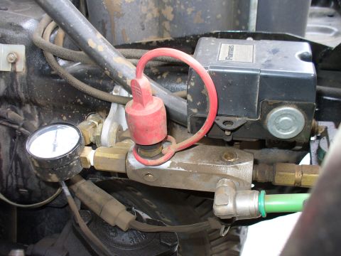 1978 Ford Bronco - This image shows parts of an on-board air system, including a pressure gauge and a control unit.