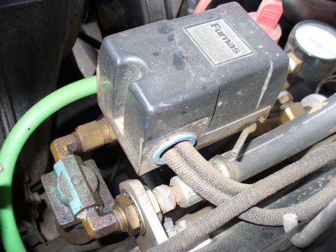 1978 Ford Bronco - A close-up view of an air system component, likely a pressure switch, with various hoses and fittings.