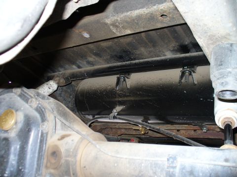 1978 Ford Bronco - Vehicle underbody with an air tank and associated plumbing visible, likely part of an aftermarket system.