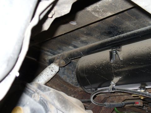 1978 Ford Bronco - Close-up of the rear shock mount and an air tank, showing suspension components.