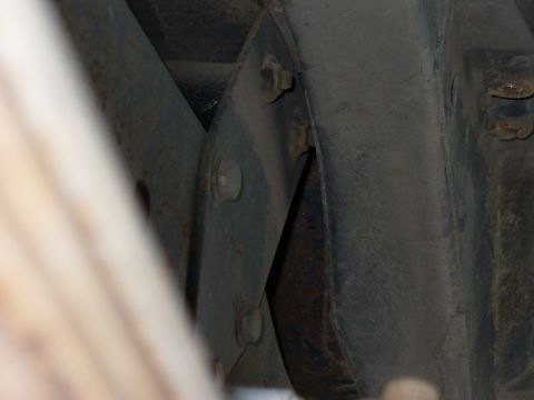 1978 Ford Bronco - Close-up view of a rear shock mount bracket, with visible bolts and metal construction.