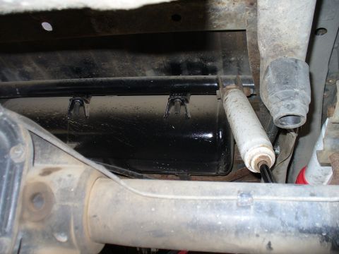 1978 Ford Bronco - Underside view of a vehicle's rear axle assembly, showing the shock absorber and exhaust system.
