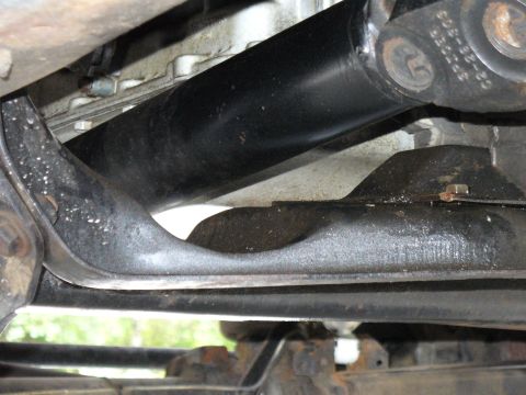 1978 Ford Bronco - Underside view of a vehicle's driveshaft and crossmember, showing mechanical components.