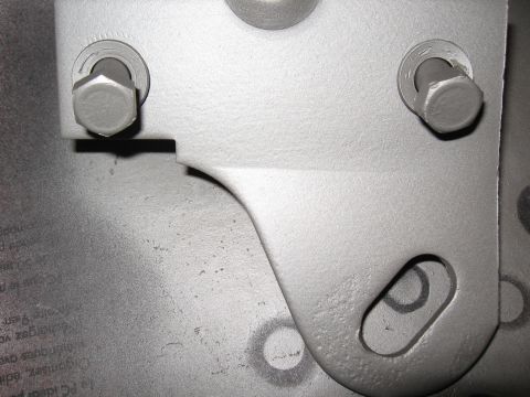 1968 Shelby GT500 - A close-up view of a metal bracket with visible text beneath its surface.