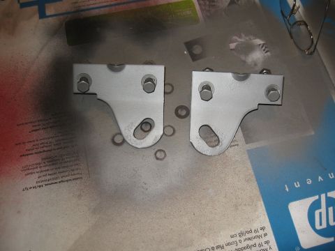 1968 Shelby GT500 - Two metal brackets, possibly for a vehicle, are shown after being painted or prepped for painting.