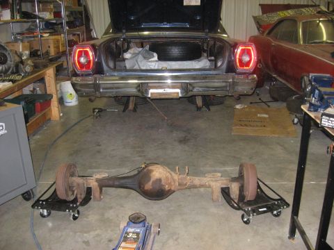 1965 Ford Galaxie - A 1965 Ford Galaxie is in a garage with its rear axle removed, while another classic car sits nearby.