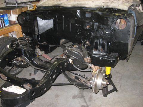 1965 Ford Galaxie - Front end of a car undergoing restoration, with the chassis and firewall exposed.