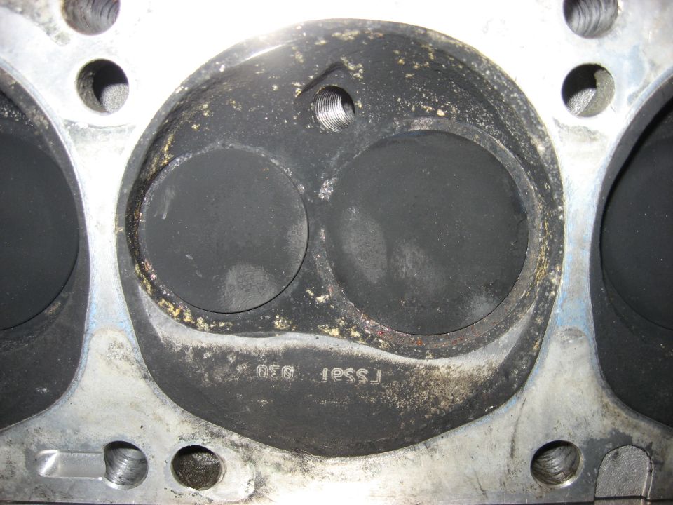 Cast-iron cylinder head combustion chamber with two valves, spark plug hole and casting numbers