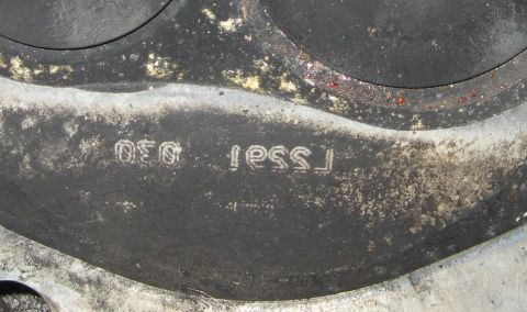 1965 Ford Galaxie - Close-up of an engine cylinder head showing stamped part identification numbers.