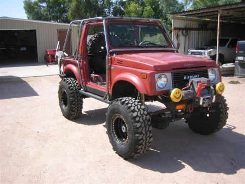 1987 Suzuki Samurai - Modified 1987 Suzuki Samurai features a full roll cage and aggressive off-road tires.