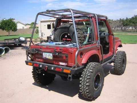 1987 Suzuki Samurai - Modified 1987 Suzuki Samurai shown from the rear, a custom roll cage and oversized tires.
