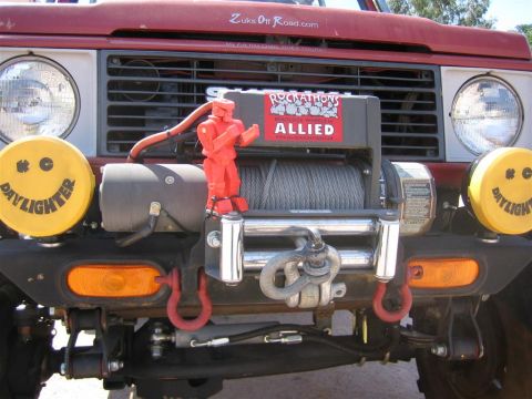 1987 Suzuki Samurai - Front view of a 1987 Suzuki Samurai equipped with a winch and auxiliary lights.