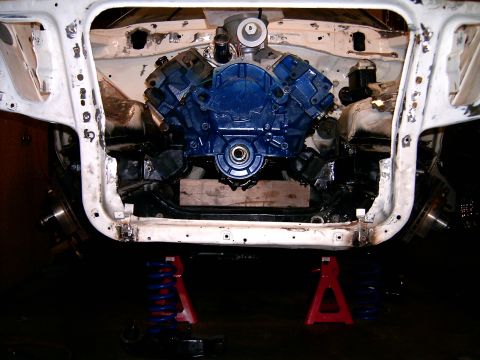 1978 Ford Mustang II - Car engine bay during restoration, with engine removed and supported on blocks and jack stands.