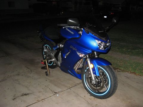 2007 Kawasaki Ninja - Front view of a blue 2007 Kawasaki Ninja motorcycle parked on a concrete driveway at night.