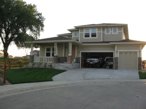 1995 Ford Bronco - A suburban house features an open garage with a pickup truck and a bicycle parked inside.