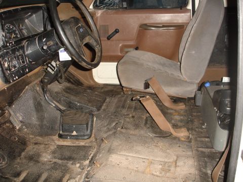 1989 Ford Bronco - Interior view of a 1989 Ford Bronco, showing the seats, dashboard, and floor.
