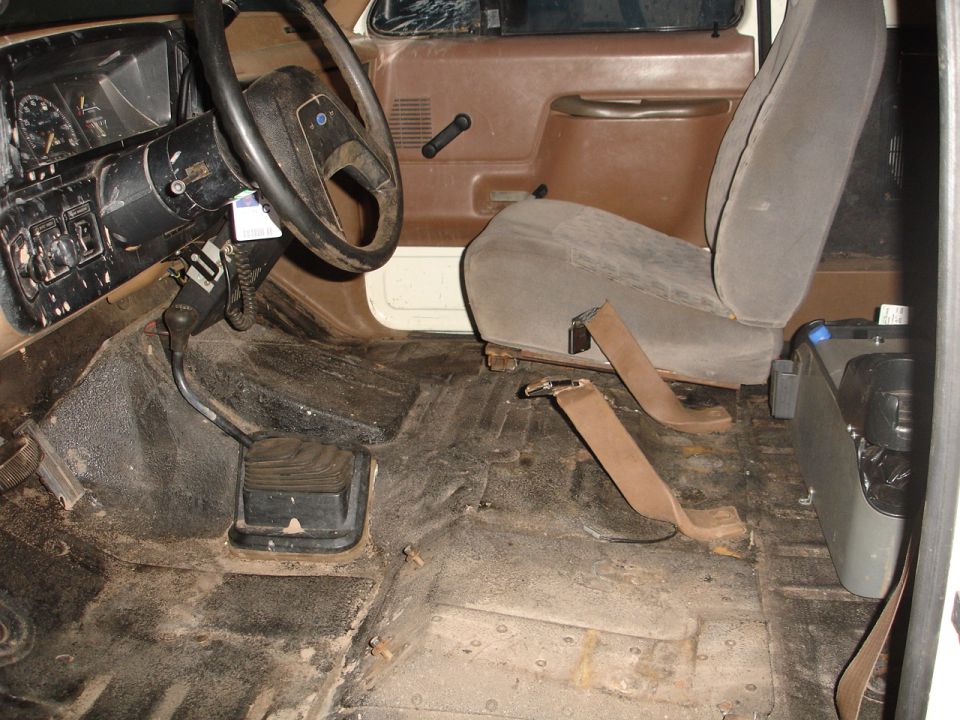 1989 Ford Bronco interior with brown seats and dashboard