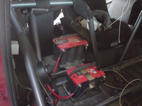 1984 Ford Bronco - Dual Optima batteries are installed in the rear of a vehicle, surrounded by a roll cage.