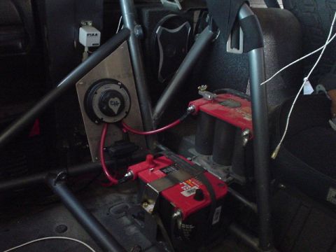 1984 Ford Bronco - Dual batteries and a CH battery disconnect switch are visible inside the vehicle's interior, connected with red wiring.