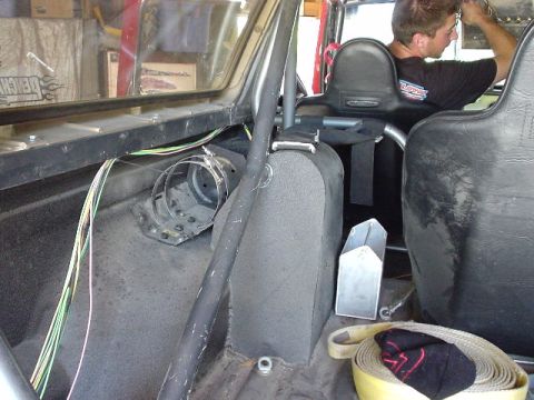 1984 Ford Bronco - Interior view of a modified vehicle showing roll cage and racing seats.