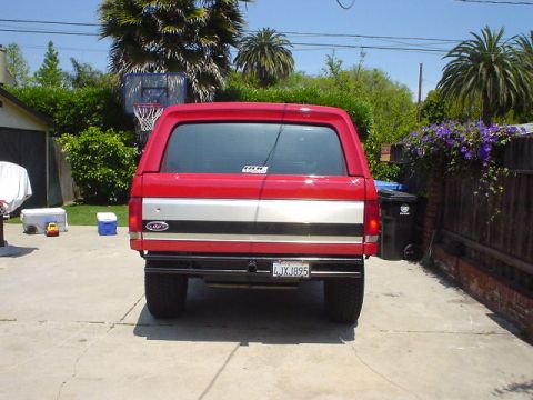 1984 Ford Bronco - Rear view of a red 1984 Ford Bronco parked in a driveway.