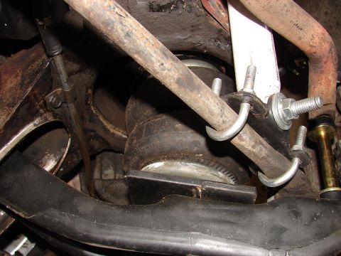 1973 Ford Ranchero - Close-up underbody shot showing a rubber air bag/air spring mounted between suspension components, secured with a galvanized U-bolt and thr…