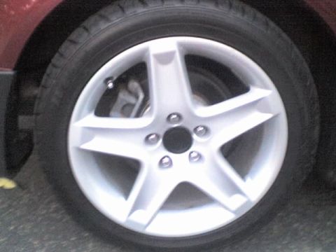 1990 Ford Bronco - Close-up of a vehicle's wheel and tire, with visible brake components.
