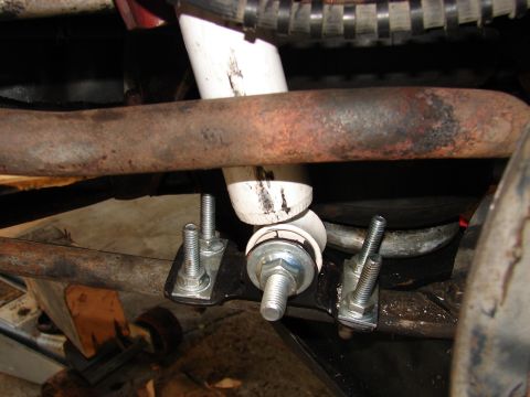 1973 Ford Ranchero - Close-up underside view of a suspension or steering component with a rusty tubular crossmember and a heavy control-arm-style bracket. A new…