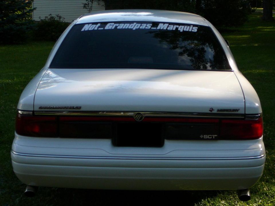 Rear of a white 1997 Mercury Grand Marquis with a "Not_Grandpas_Marquis" sticker on the back window