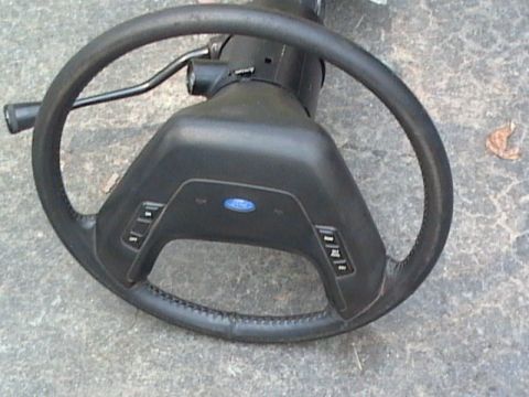 1990 Ford Bronco - Steering wheel and column assembly from a Ford vehicle.