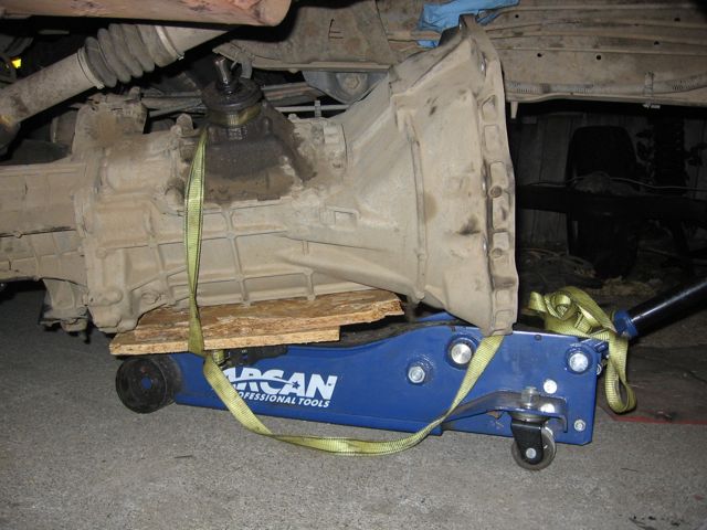 vehicle transmission supported by a blue jack with straps