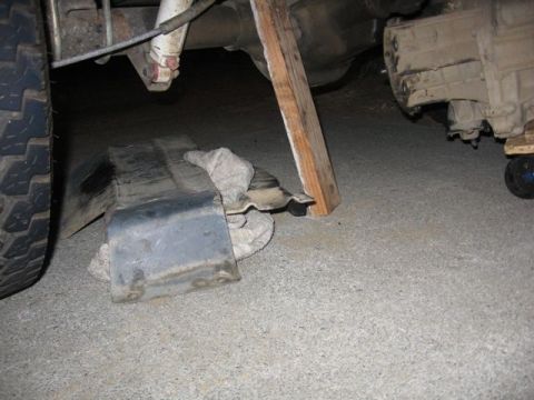 1989 Ford Bronco - Undercarriage view of a vehicle, showing mechanical components and a tire.