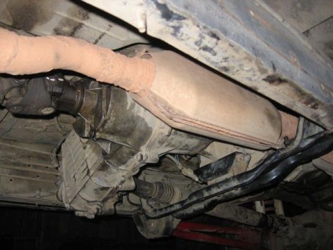 1989 Ford Bronco - Underside view of vehicle transmission, driveshaft, and exhaust system.
