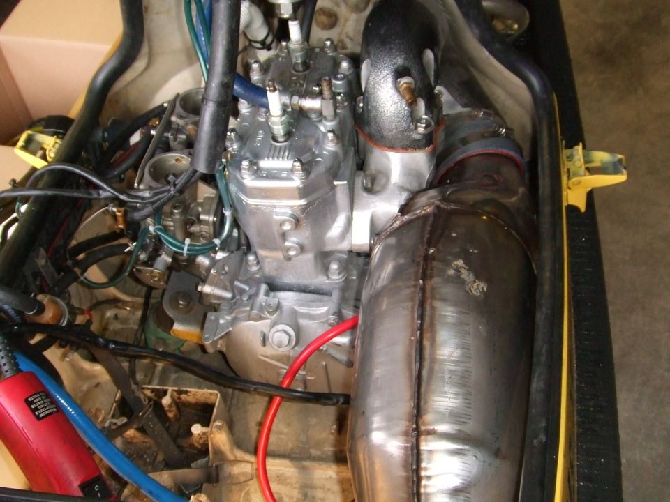 Jet ski two-stroke engine bay with carbs and polished tuned exhaust chamber