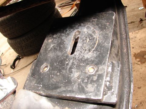 1973 Ford Ranchero - Close-up of a shop-fabricated black steel mounting plate with a machined slot down the center and two counterbored bolt holes, welded to an…