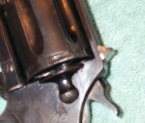 1996 Ford Bronco - A close-up view of a firearm's cylinder and frame, with a website address visible at the bottom.