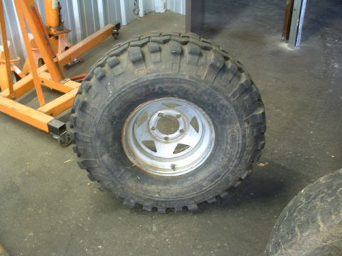 1994 Jeep YJ - A single tire and rim are shown, with another tire partially visible to the right. The registry claims it is a 1994 Jeep YJ, but this is un…