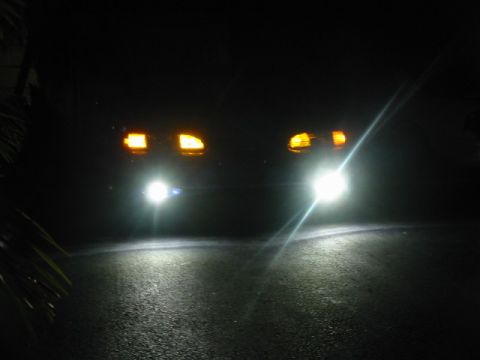 1995 Ford Thunderbird - Front view of a 1995 Ford Thunderbird with headlights illuminated at night.