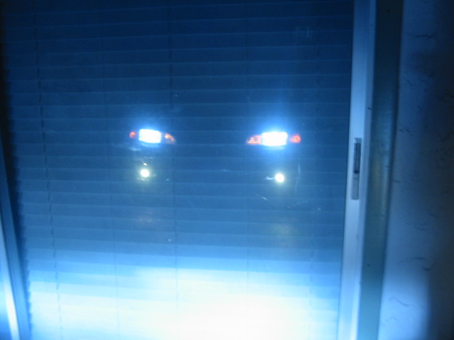 Headlights glowing through blinds
