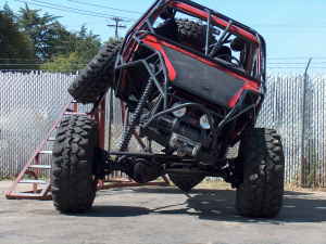 1989 Ford Bronco - This heavily modified off-road buggy is seen from the rear, mounted on a ramp.