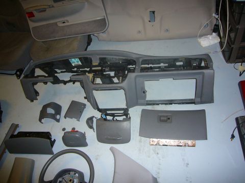 2000 Ford Crown Victoria - Various disassembled interior components are laid out, suggesting a repair or restoration project.