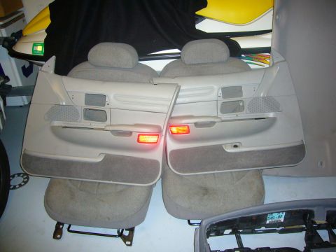 2000 Ford Crown Victoria - Interior door panels and seats are shown, with amber reflectors illuminated on the panels.
