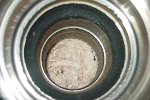 1993 Ford Bronco - Close-up view inside a metal pipe, revealing fuzzy material at the bottom and the Supermotors logo in the corner.