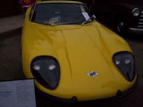 1972 Ford Ranchero - A yellow Marcos sports car is displayed with a sign detailing its specifications.