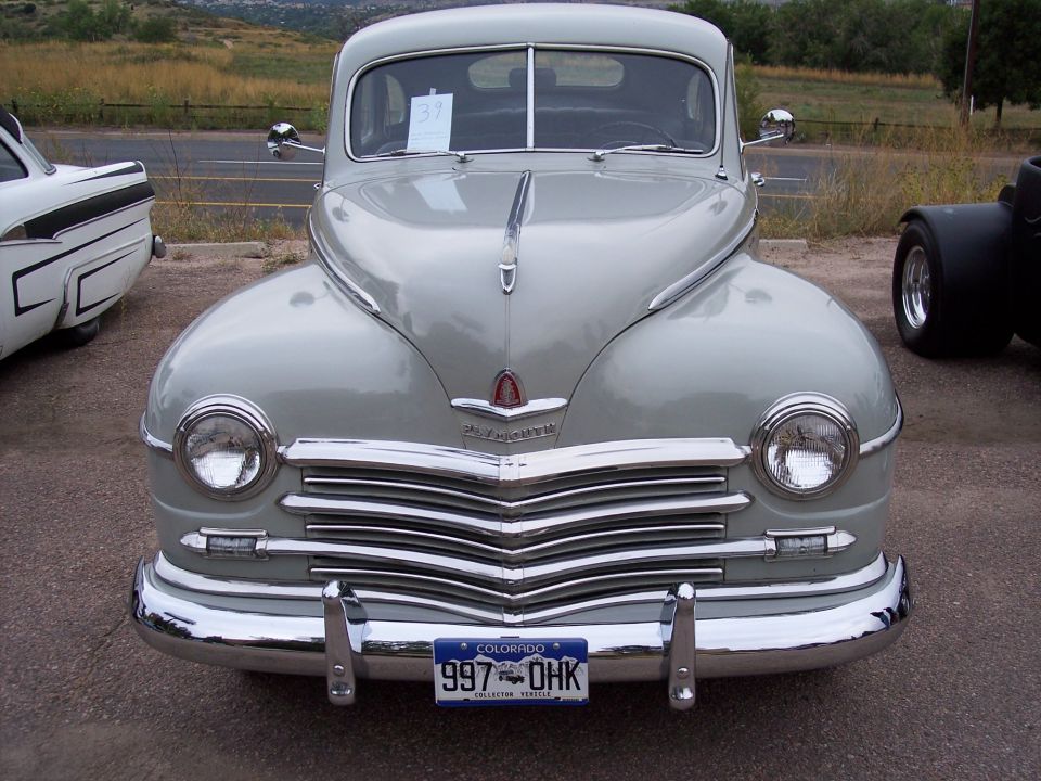 Gray vintage car front view with chrome grille and Colorado license plate