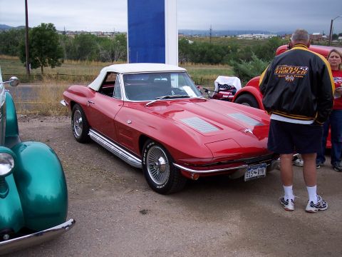 1972 Ford Ranchero - Red convertible sports car with white top and chrome side pipes. License plate reads B15-AYK.