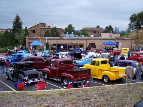 1972 Ford Ranchero - A variety of vintage vehicles are gathered in a parking lot, possibly for a car show.