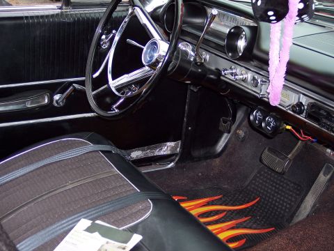 1972 Ford Ranchero - Interior view of a vintage automobile, custom floor mats and a classic steering wheel.